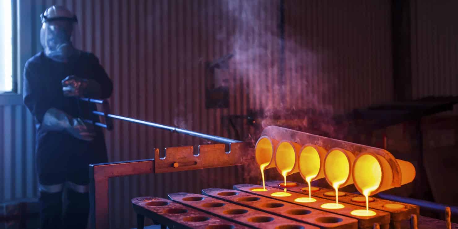 Man pouring hot gold into a mold
