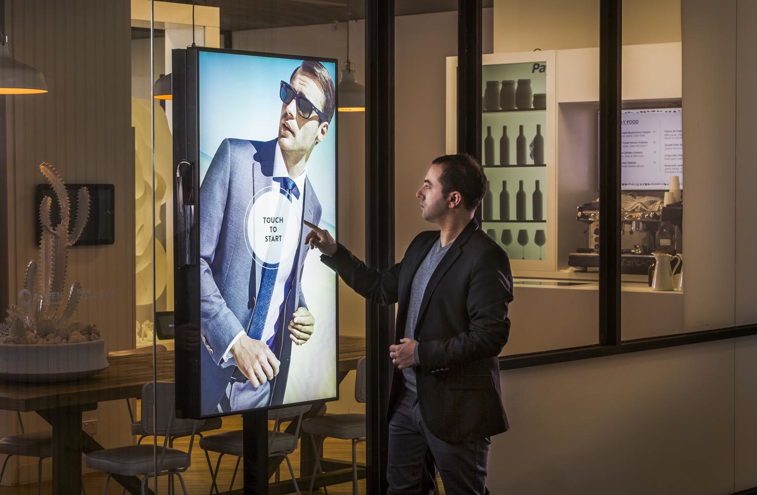 Man with retail shop window technology