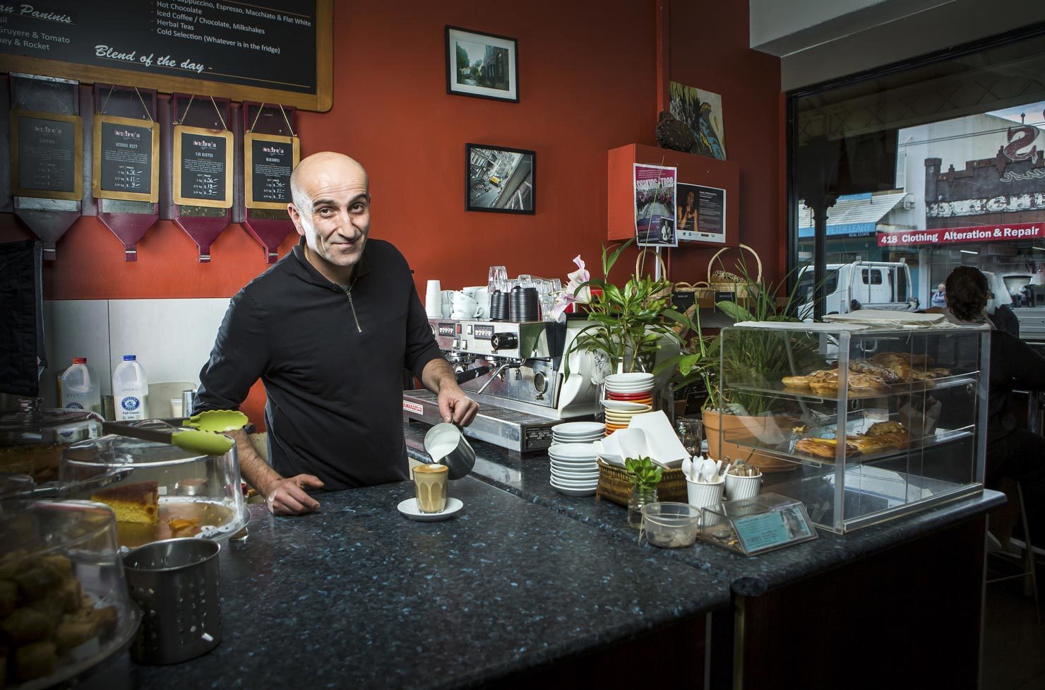 A barista pours a coffee in a Brunswick cafe. Client Jemena