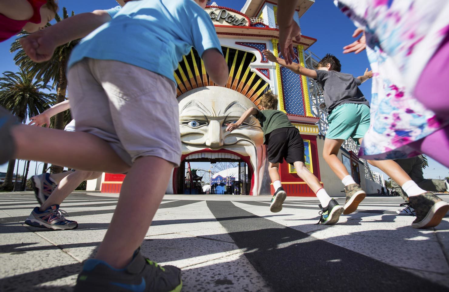 Kids run for the entrance of Luna Park