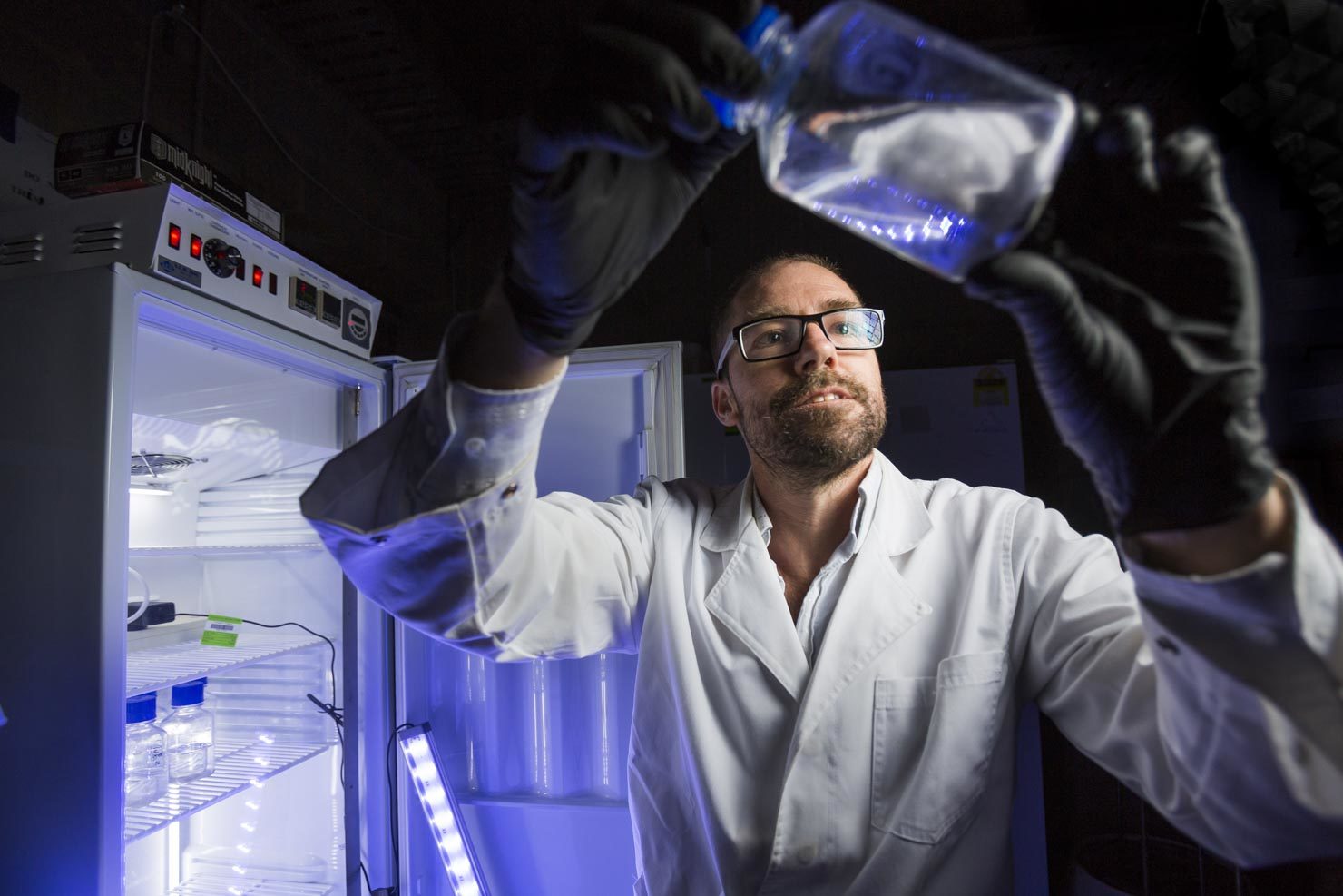 Scientist in lab with liquid